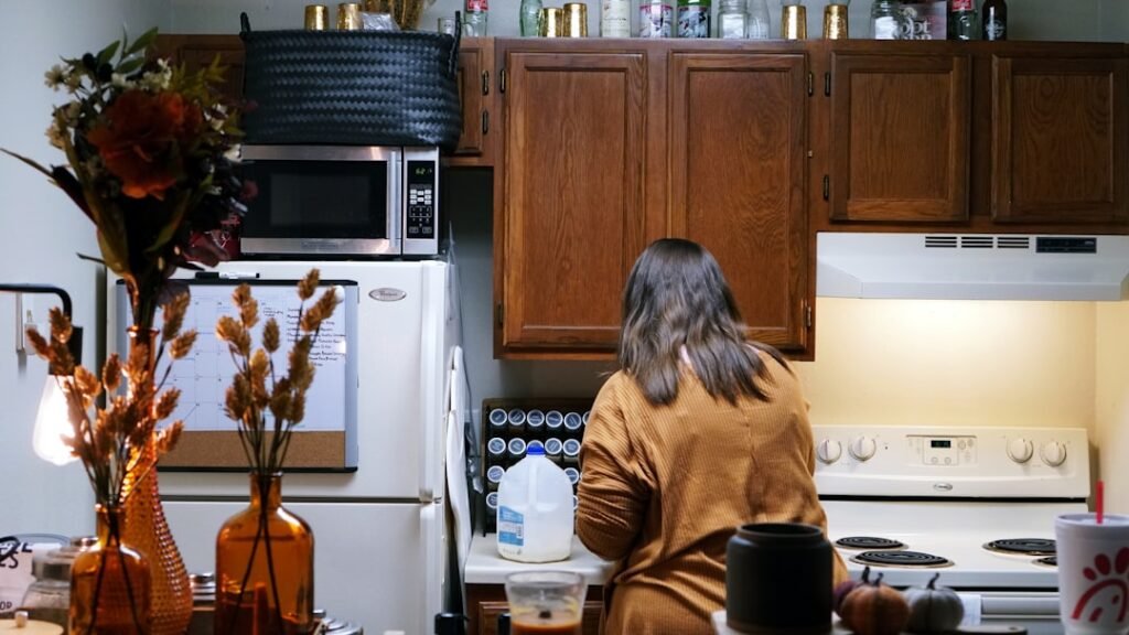 One person cooking in a small apartment kitchen