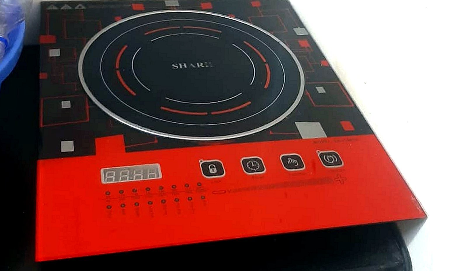 A compact portable induction cooktop set up on a countertop in a small kitchen