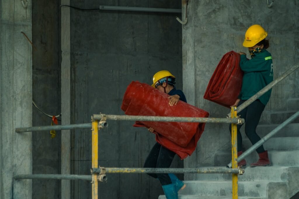Construction worker wearing an orange hard hat at a jobsite