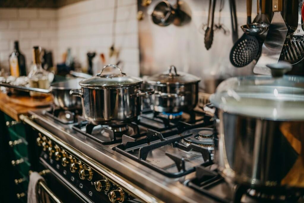Stainless steel pots on a gas stove; illustrative cookware photo