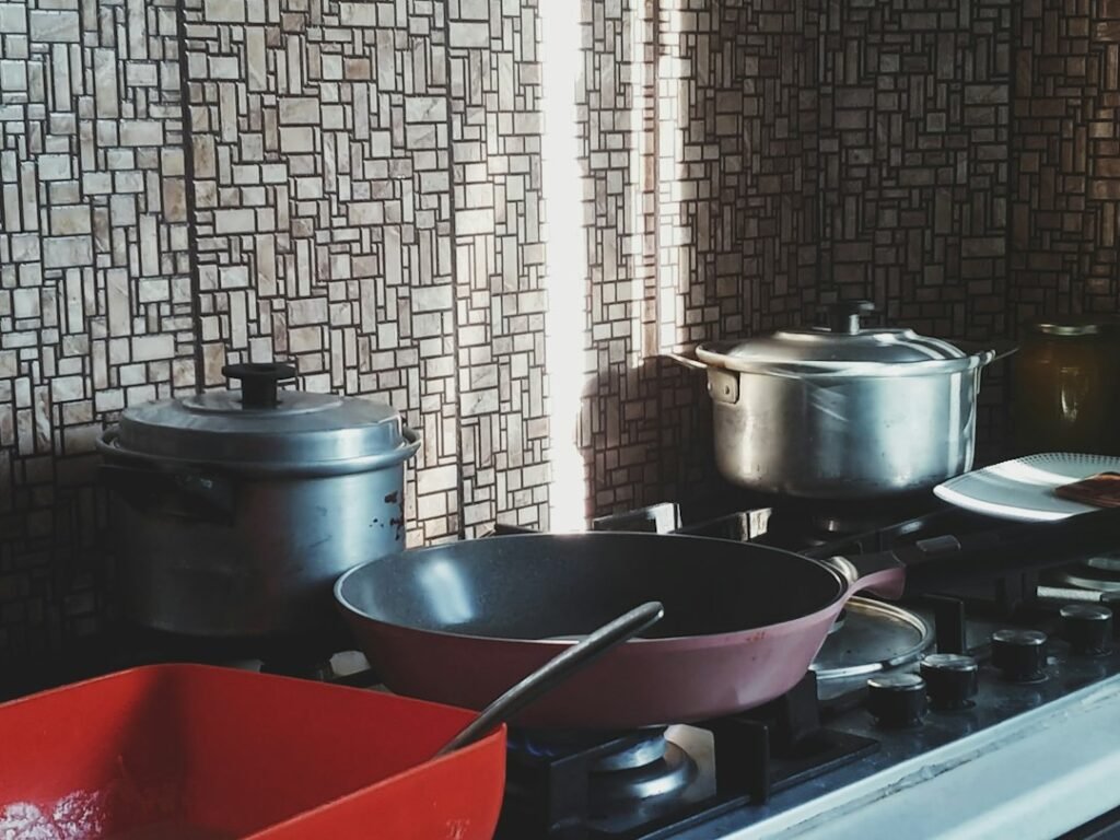 Pots and pans on a stovetop, illustrating induction versus hot plate cooking