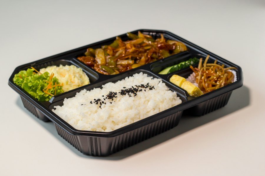 A prepared bento lunch arranged in a meal container