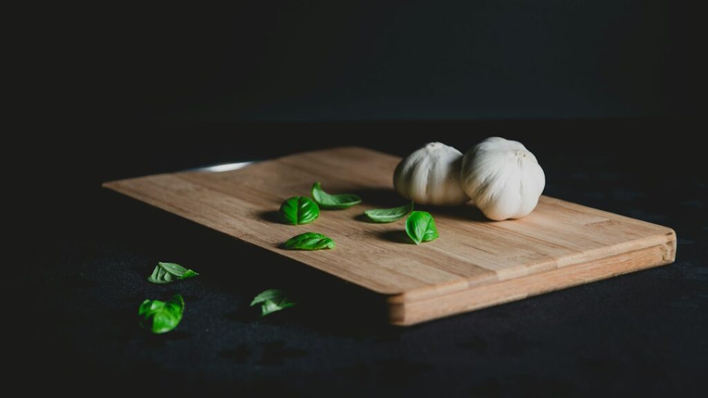 Fresh garlic and basil, common small-batch ingredients for a mini food processor