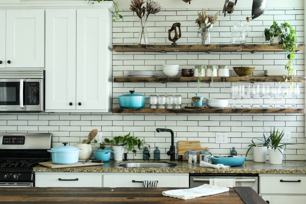 An organized kitchen with open wooden shelves and clear countertop space