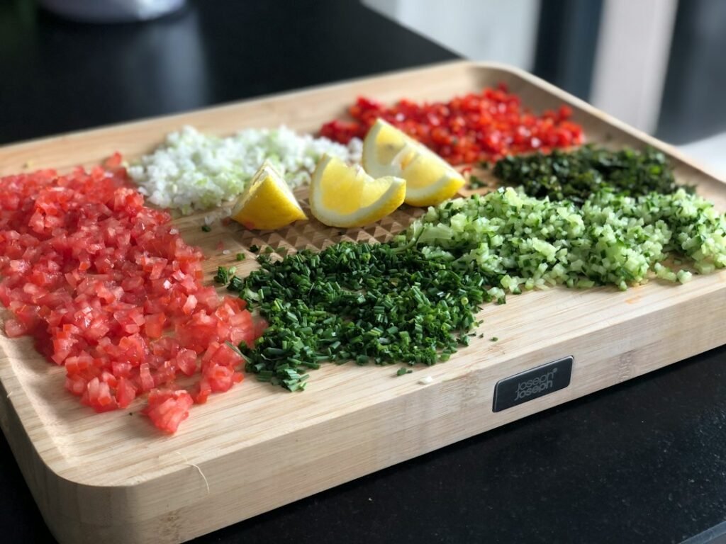 Uneven pieces of chopped vegetables on a cutting board for mini food processor troubleshooting