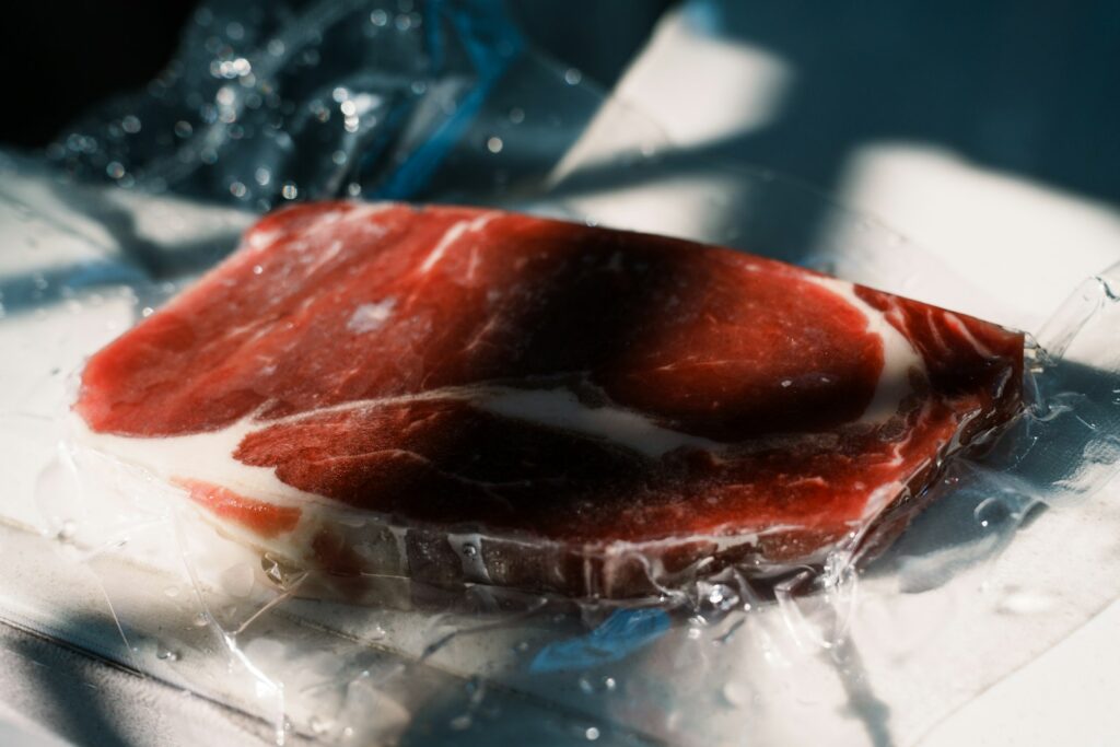 Raw steak vacuum-sealed in plastic for storage