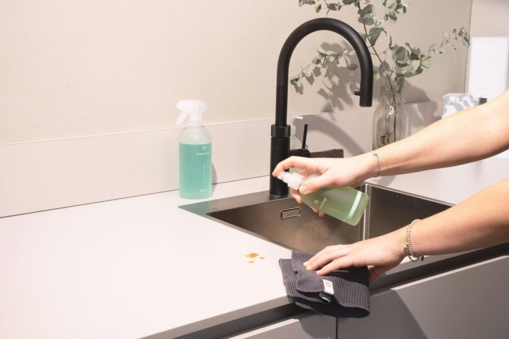 Cleaning a kitchen appliance pot at the sink