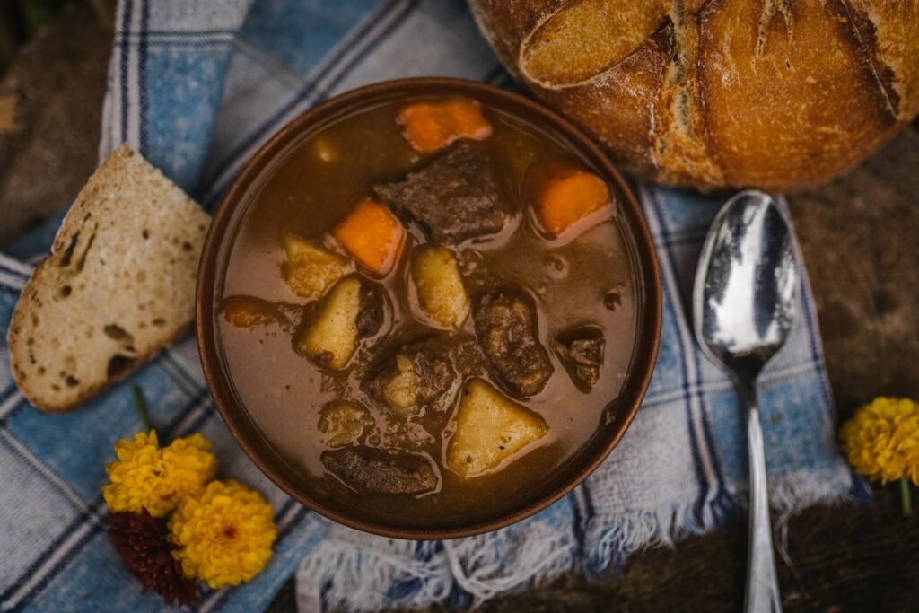 A hearty slow-cooked beef stew with bread, the kind of meal a slow cooker or Instant Pot makes
